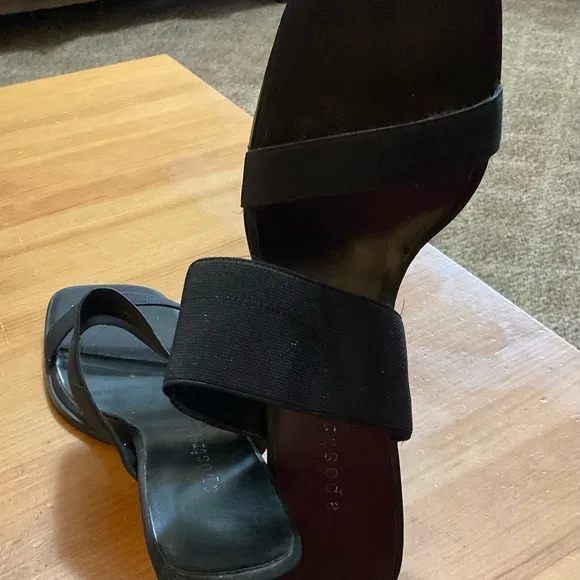 Black sandals with about a inch heel.