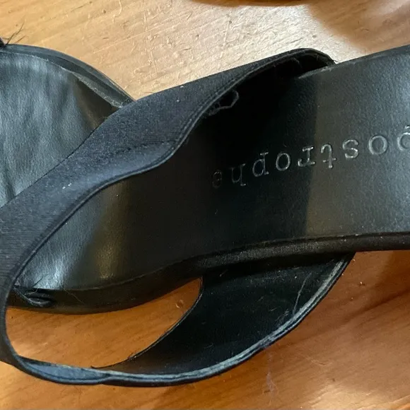 Black sandals with about a inch heel.